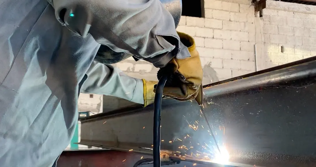 ProCONECT welder working on a steel part with welding sparks