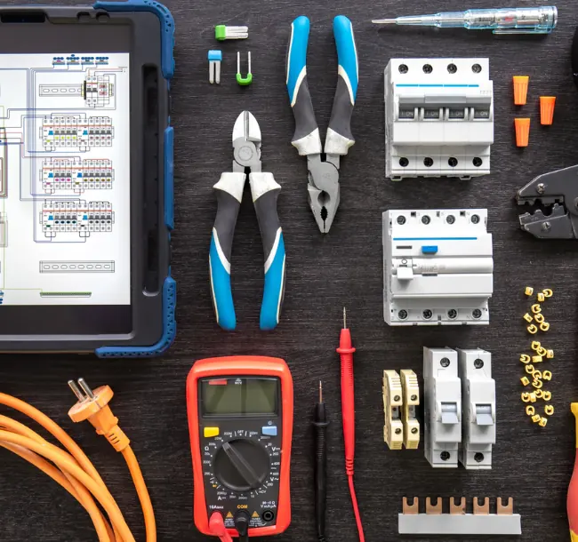 Electrical tools and materials: breakers, multimeter, pliers and cable